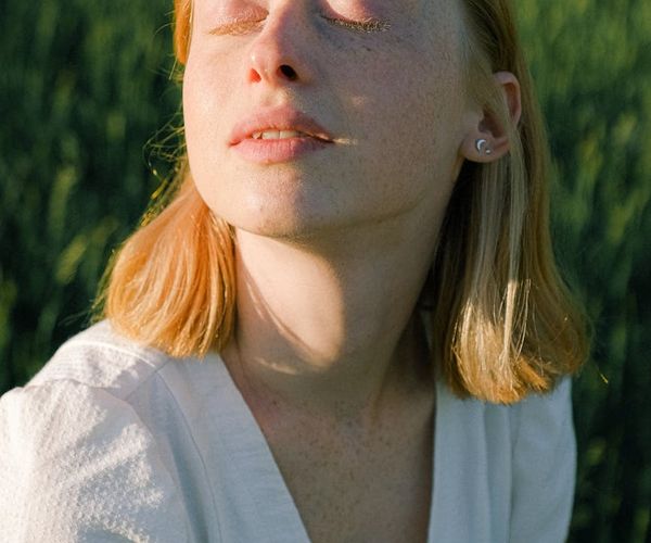 Close-up of a person taking a deep, calm breath with closed eyes.